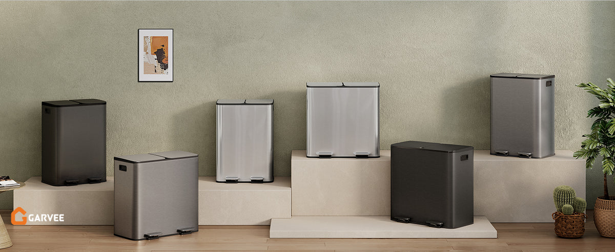 A row of stainless steel dual compartment trash cans and a recycling bin displayed on a wooden surface.