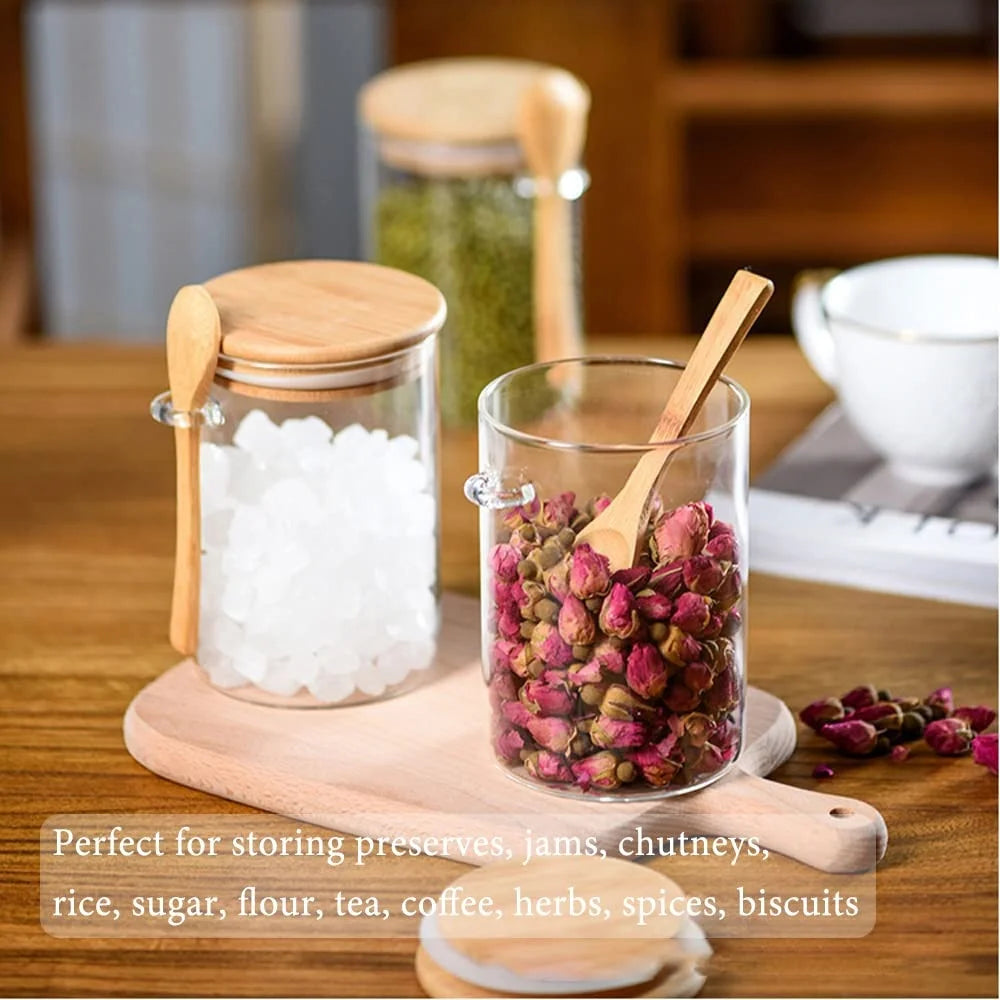 A glass jar filled with dried herbs and spices sits on a wooden board next to a bamboo lid.