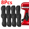 Eight black adhesive cord organizers for kitchen appliances shown next to a red appliance.