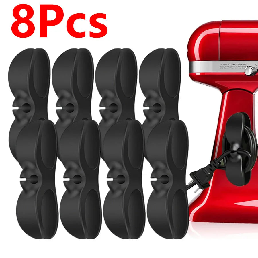 Eight black adhesive cord organizers for kitchen appliances shown next to a red appliance.