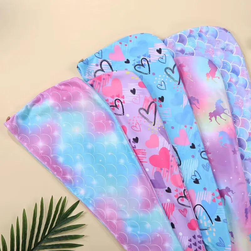 A set of colorful microfiber hair drying caps featuring pink, blue, and purple patterns.