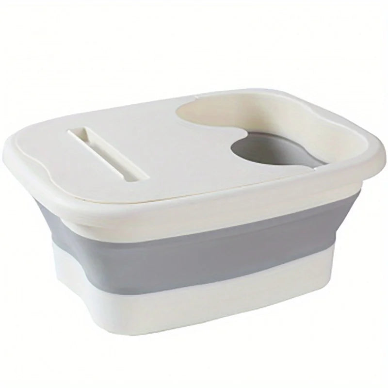A white and gray collapsible foot soak bucket with massage dots.