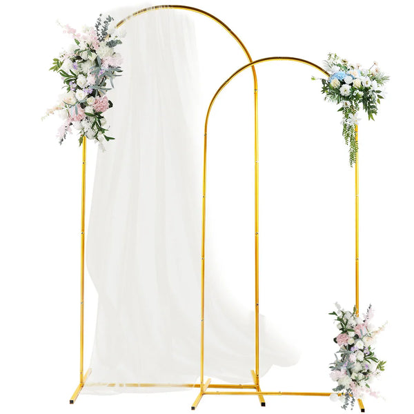 Gold metal wedding arch backdrop stand set with sheer white draping and floral arrangements