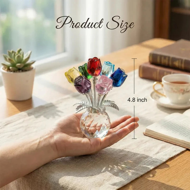 A hand holds a crystal rose flower figurine in a glass vase, showcasing its size.