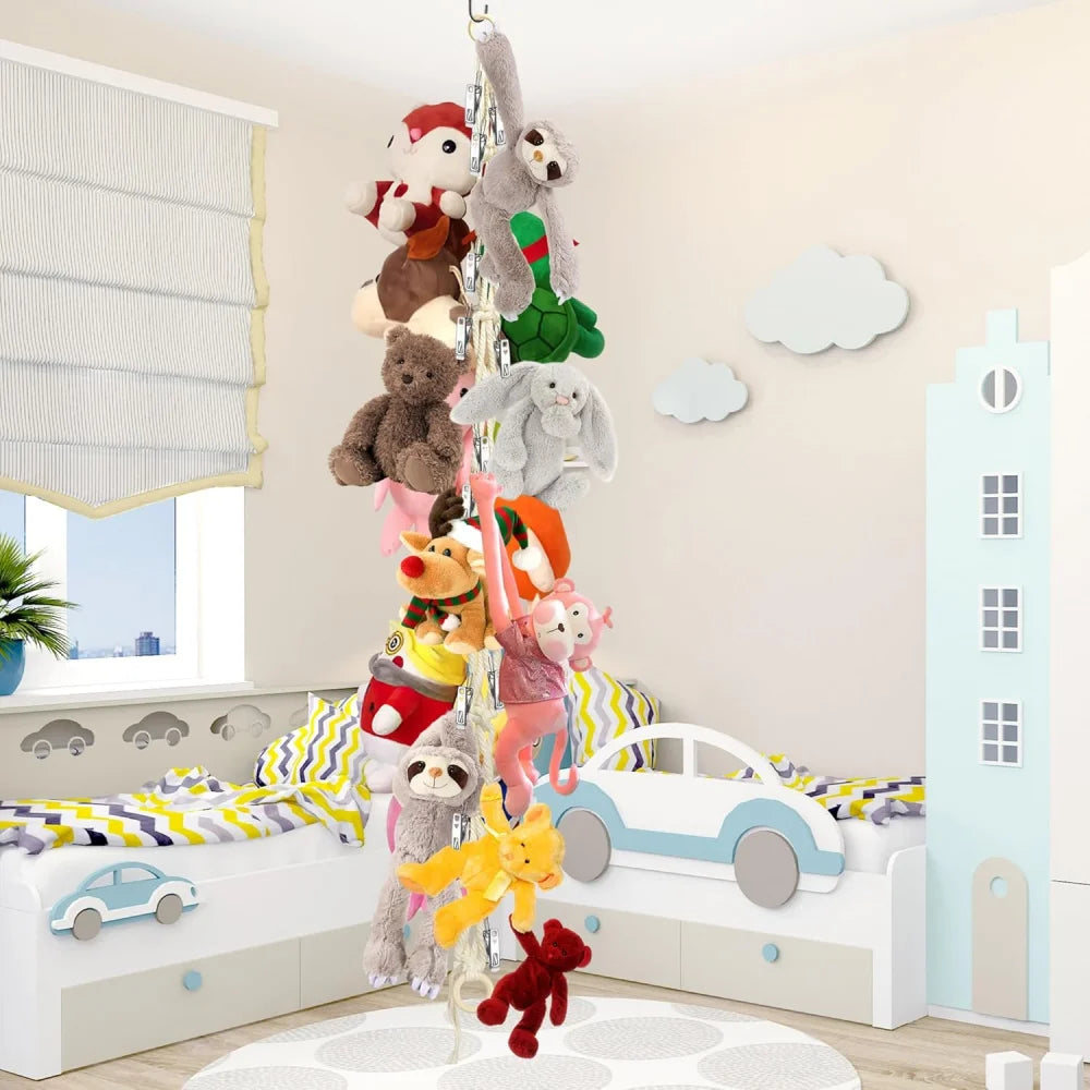 A white bedroom decorated with a hanging storage chain featuring stuffed animals and a toy car.