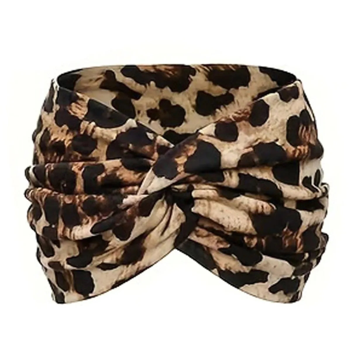 A black and white leopard print elastic knot yoga and fitness headband tied around the head.