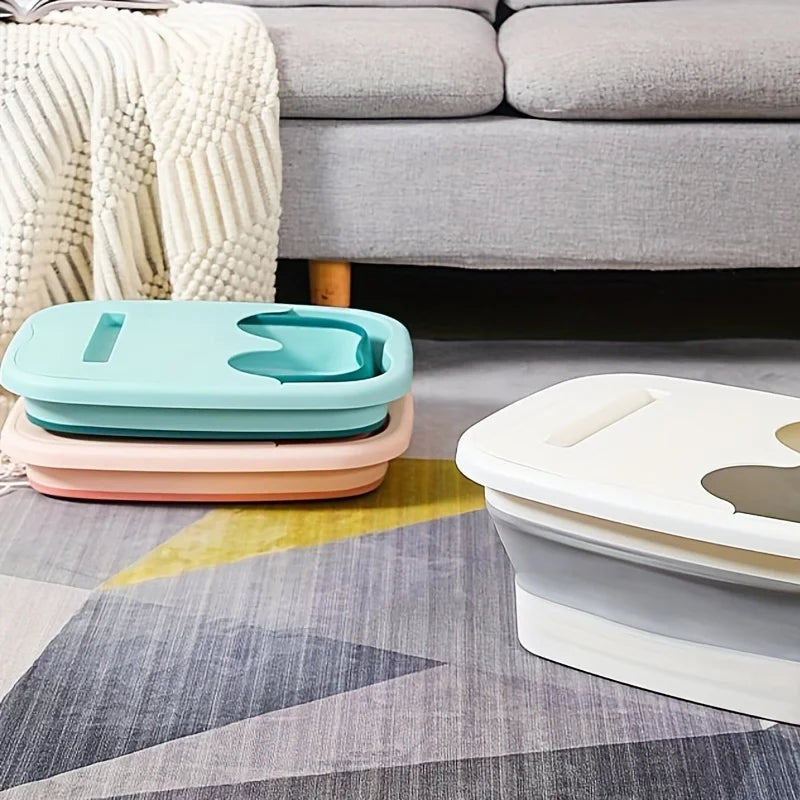 Two plastic foot soak buckets in mint green and pink resting on a gray patterned rug.