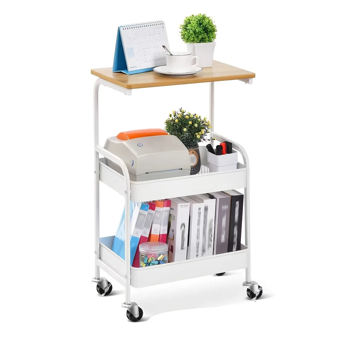 A white 3-tier rolling storage cart with a wooden top holding stationery and a small potted plant.