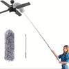 A person is holding a telescopic extendable duster pole for high areas.