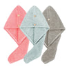 Three folded quick-dry microfiber hair towel wraps in pink, mint green, and gray.