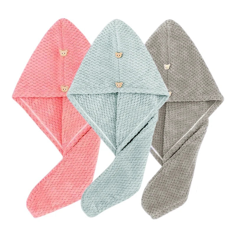Three folded quick-dry microfiber hair towel wraps in pink, mint green, and gray.