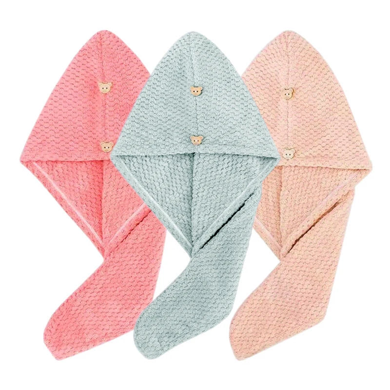 Three folded quick-dry microfiber hair towel wraps in pink, mint green, and peach tones.