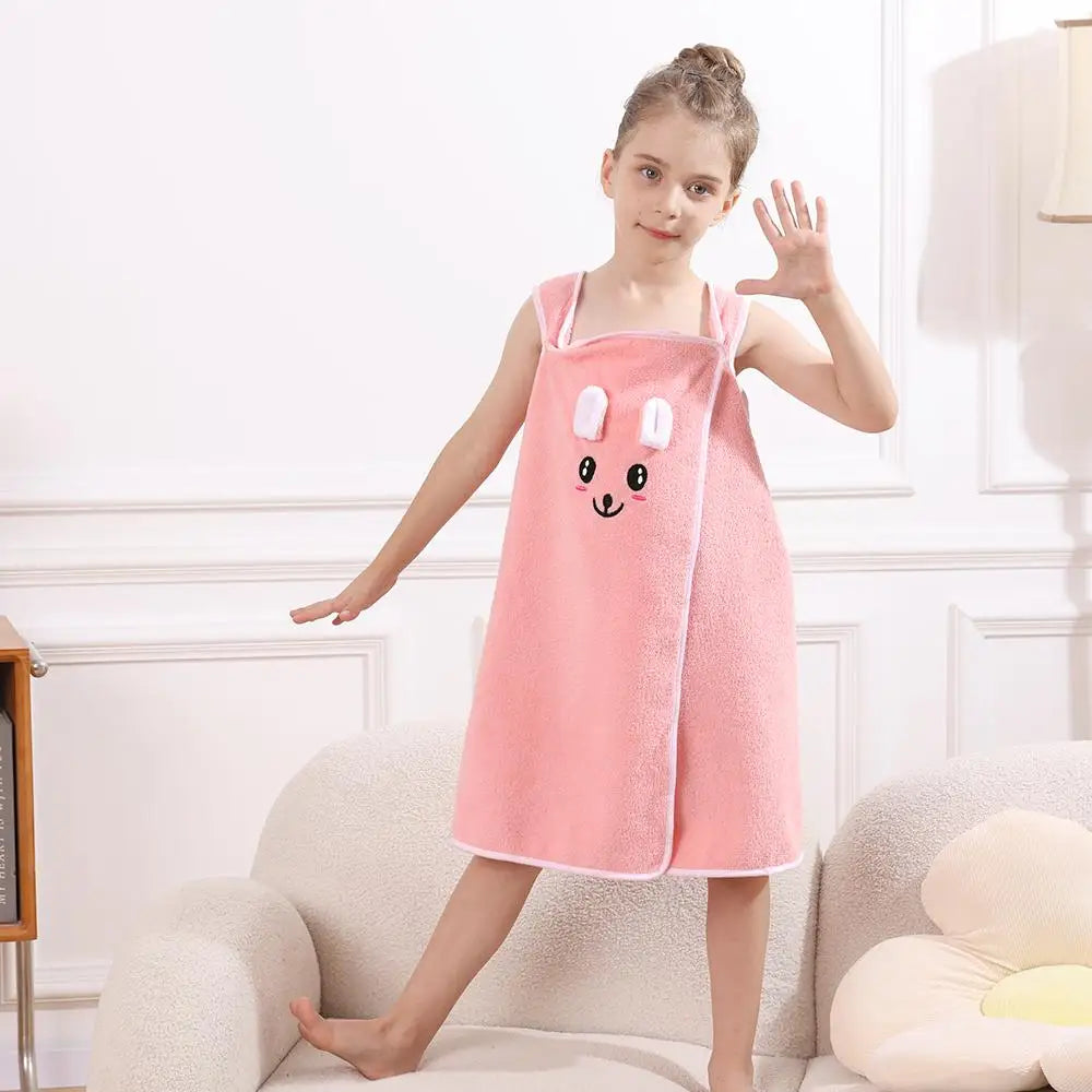 A young girl wearing a pink microfiber bath towel wrap with bunny ears.