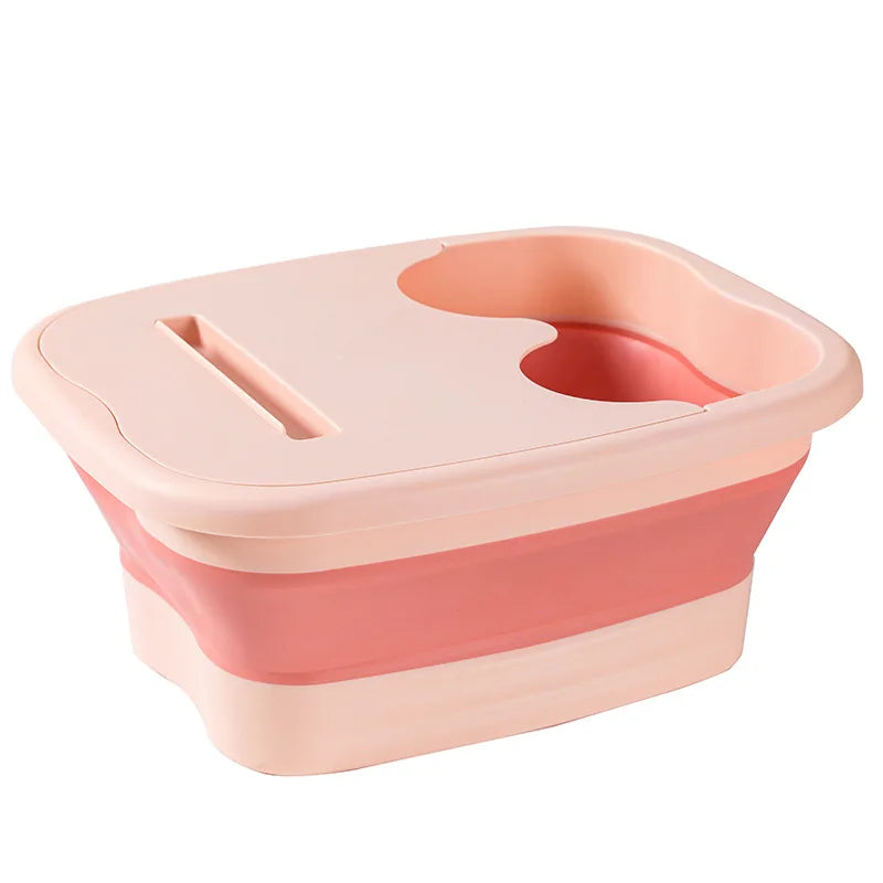 A pink collapsible foot soak bucket with massage dots.