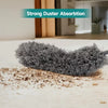 A grey telescopic duster with dense bristles is shown cleaning a white floor.