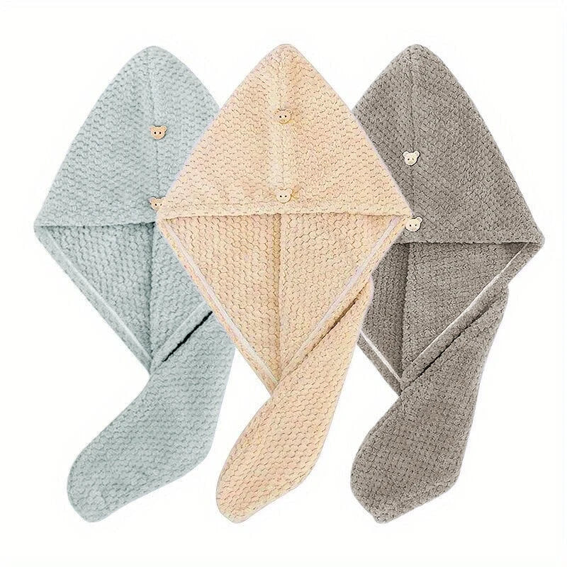 Three folded quick-dry microfiber hair towel wraps in light blue, beige, and gray.