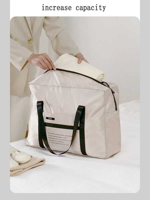 A beige foldable travel duffel bag is shown being held by a person, demonstrating its increased capacity.