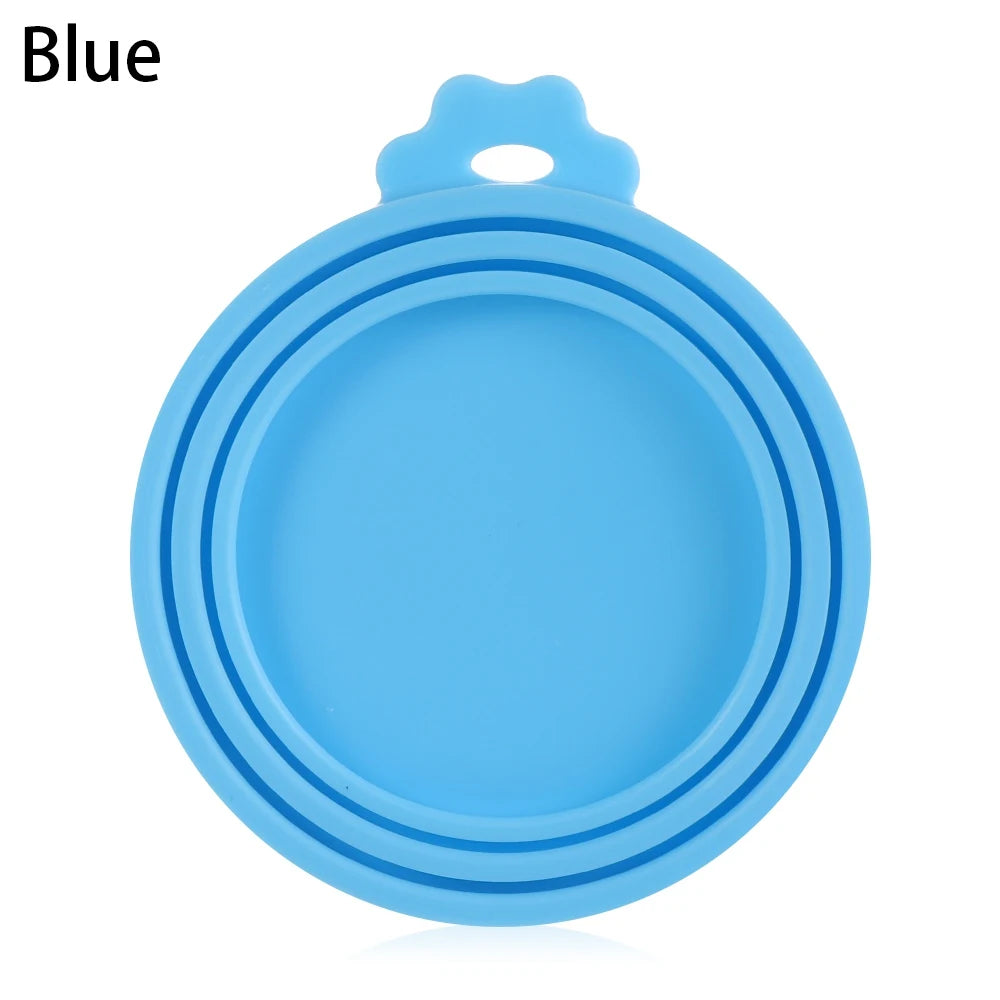 A blue silicone reusable food storage lid or cover with a small loop for hanging.