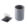 A gray wall mounted organizer featuring a cup and toothbrush holder.