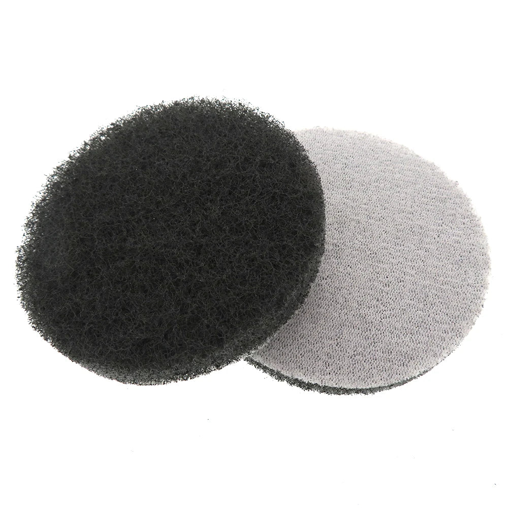 Two circular scouring pads, one black and one gray, are shown against a white background.