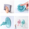 A hand demonstrates a strong suction cup hook with waterproof grip for a no-drill wall mount.