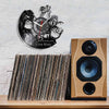 A wall clock shaped like a lion with a face and a vinyl record display, positioned above a stack of vinyl records.