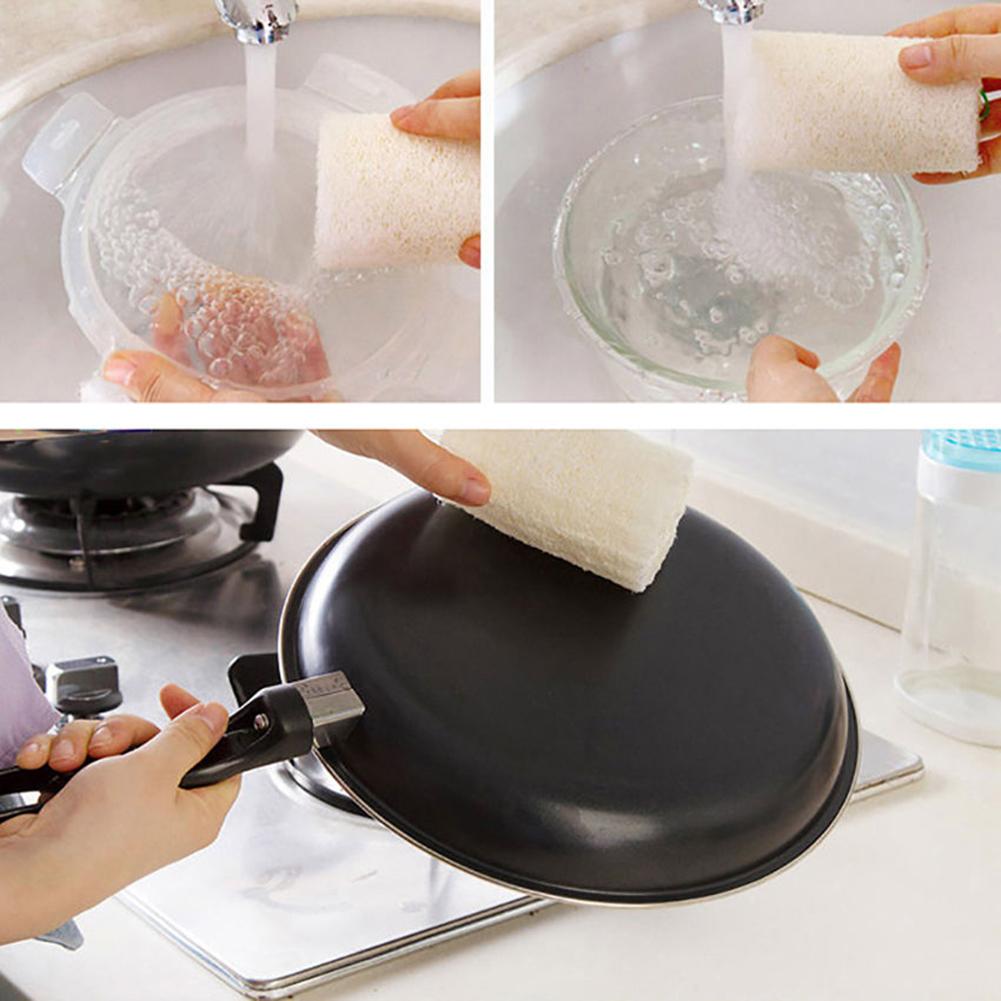 A set of natural loofah sponges being used for cleaning in a kitchen and bath setting.