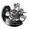 A wall clock face designed with a lion theme featuring various lion imagery and a vinyl record design.