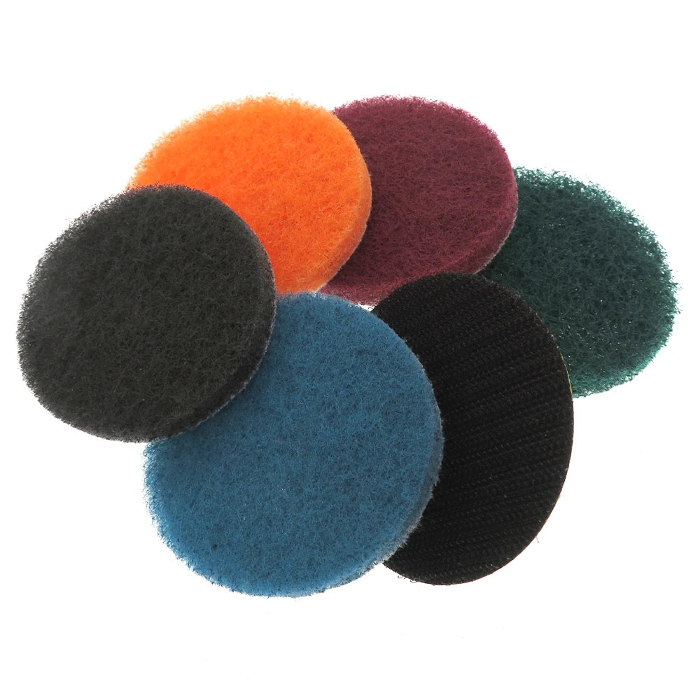A collection of various colored heavy-duty nylon scouring pads in a pile.