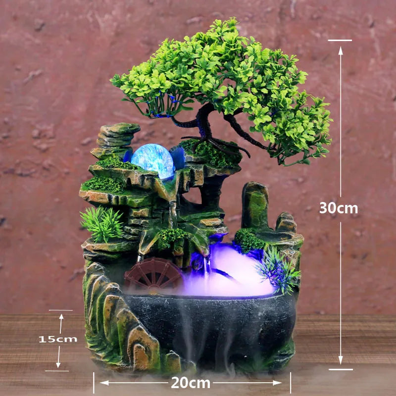 A miniature resin water fountain featuring a mossy rock landscape and a green tree with a small waterfall.