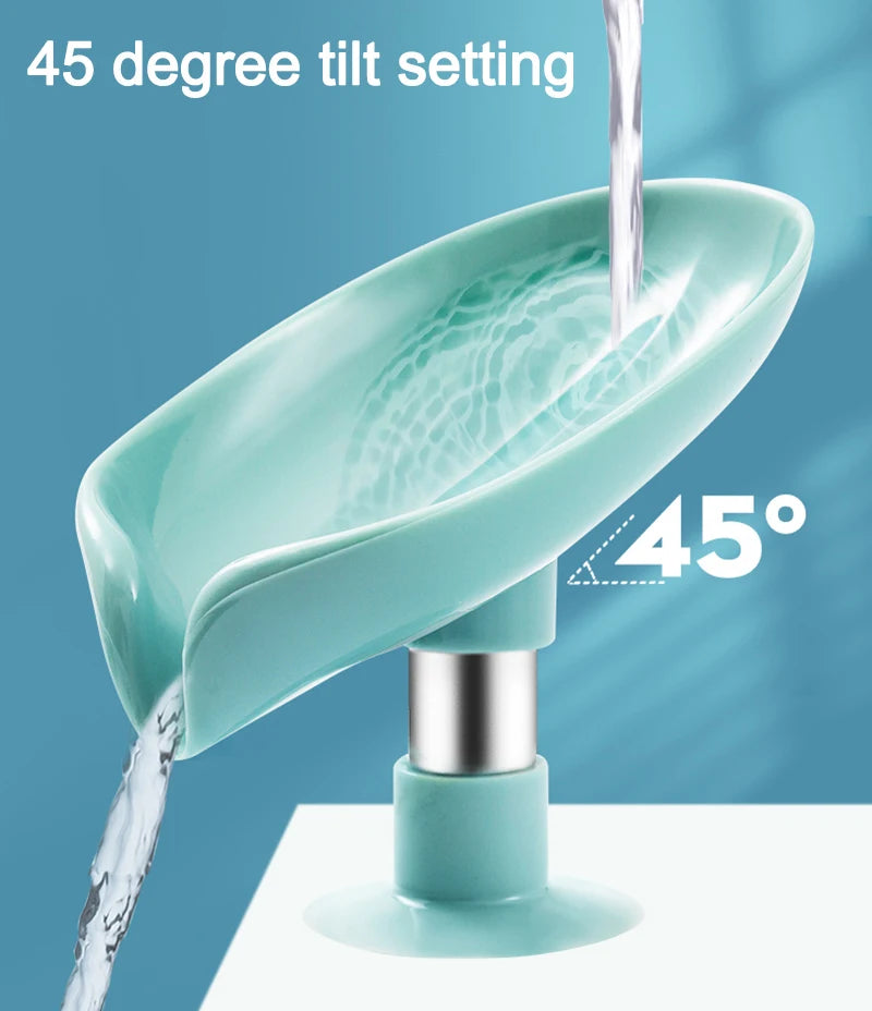 A teal leaf-shaped suction cup soap dish is shown tilting at a 45-degree angle, with water flowing into it.