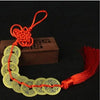 Handmade red knot feng shui coins strung together on a cord
