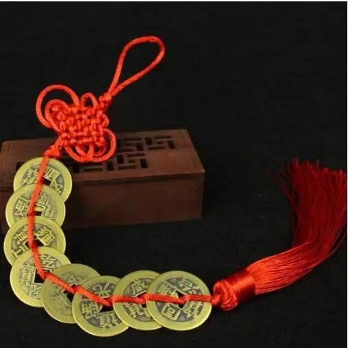 Handmade red knot feng shui coins strung together on a cord