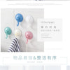 A set of light blue and white suction cup hooks for wall mounting in a bathroom or kitchen setting.