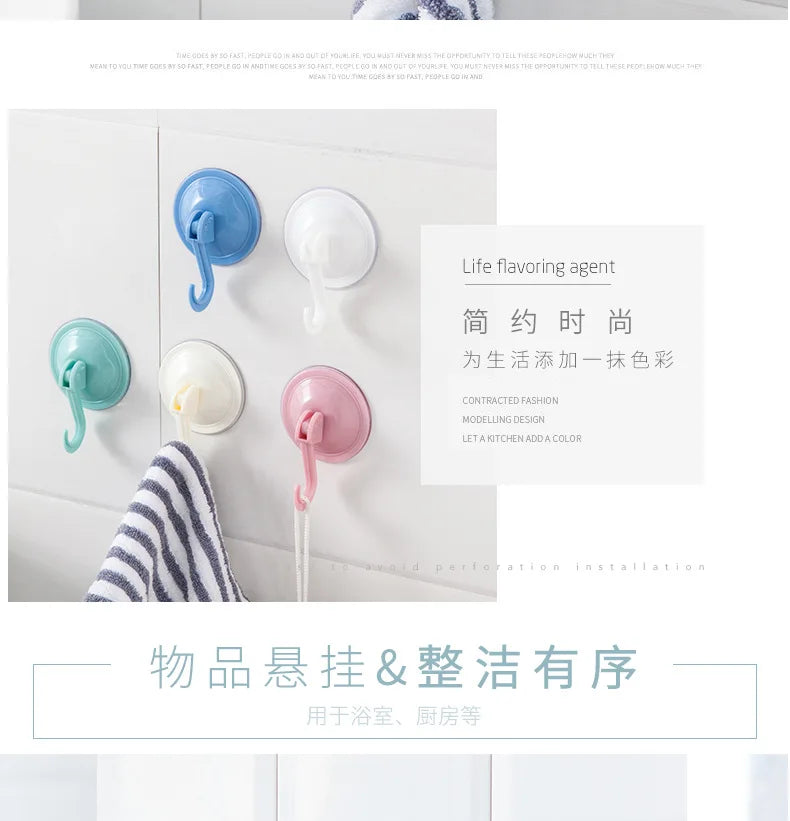 A set of light blue and white suction cup hooks for wall mounting in a bathroom or kitchen setting.