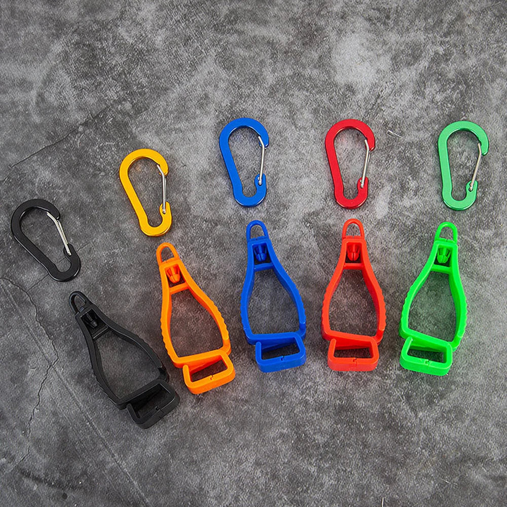 A collection of colorful durable glove clips and buckles arranged on a gray surface.