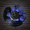 A wall clock featuring a dark lion head and skeletal figures, with a blue glow effect.
