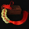 Handmade red knot feng shui coins for prosperity with a red cord and wooden box.