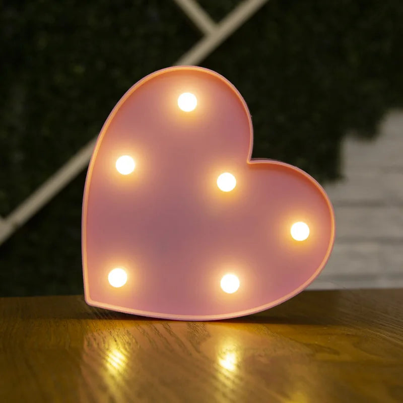 A pink heart-shaped LED light decoration with multiple glowing lights.