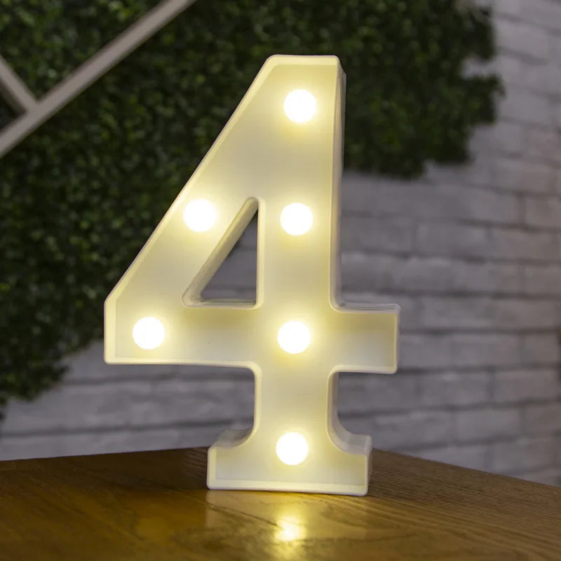 A glowing white LED light shaped like the number four rests on a wooden surface.