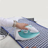 A hand is placing a white iron with a light blue heating plate onto a striped ironing protection mesh pad.