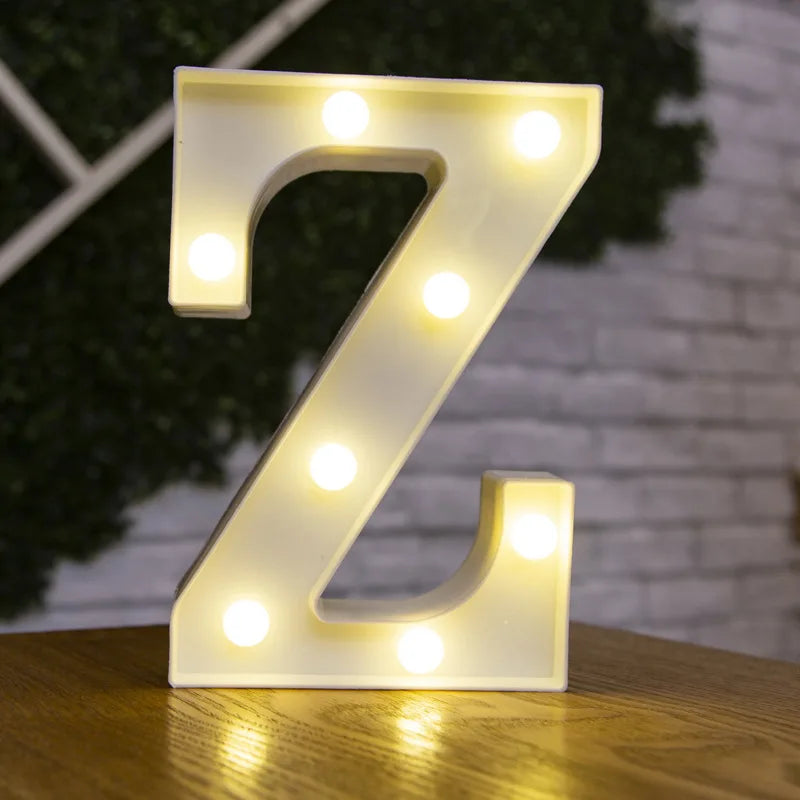 A glowing white letter Z made of LED lights resting on a wooden surface.
