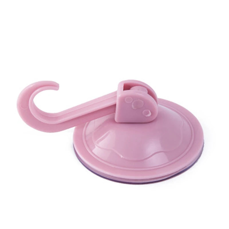 A pink strong suction cup hook with a waterproof grip used for hanging items on walls.