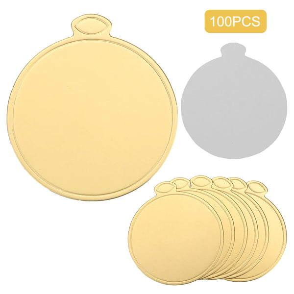 A set of 100 disposable gold round cake display boards, including a single board and several stacked boards.