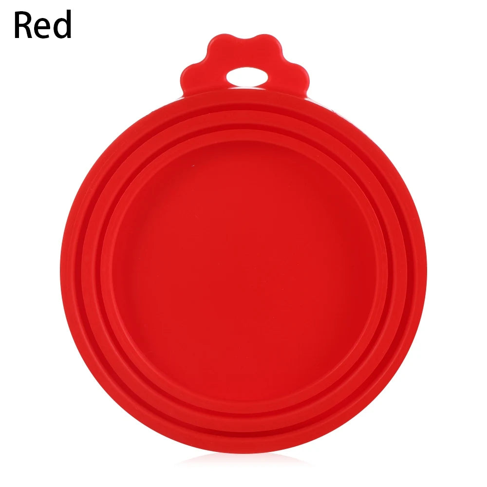 A red silicone reusable food storage lid with a handle.