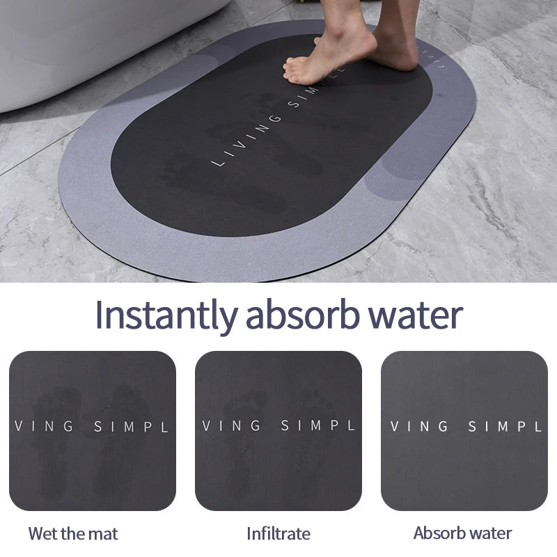 A black non-slip bath mat is shown absorbing water on a gray tiled floor.