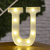 A white alphabet light fixture shaped like the letter U, illuminating the surface below.