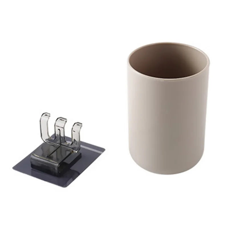 A beige ceramic cup and toothbrush organizer mounted on a black plate.