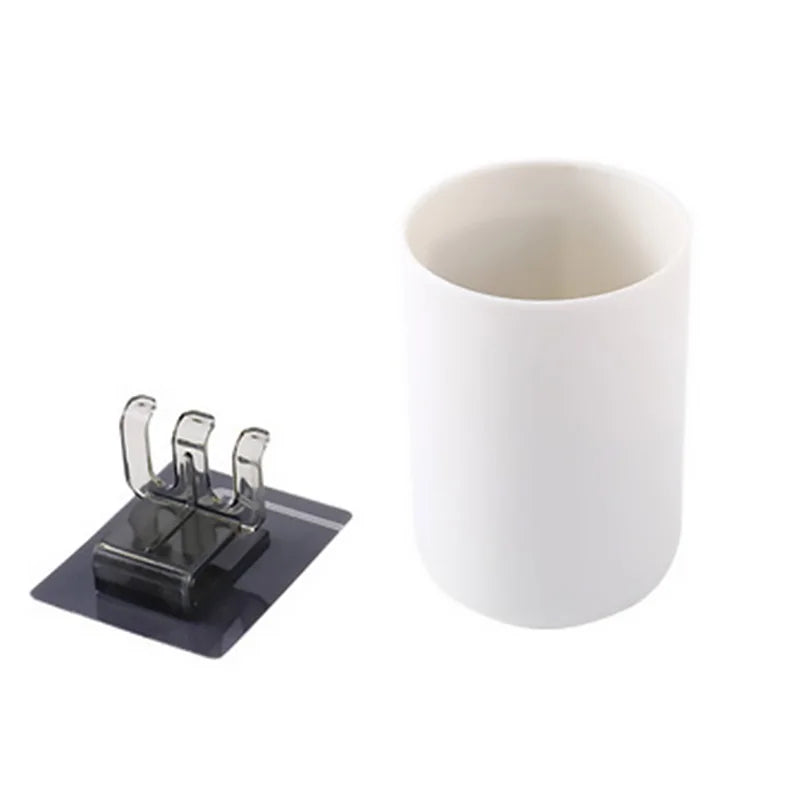 White ceramic cup and toothbrush organizer mounted on a black holder