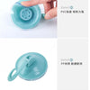 A hand is holding a clear blue suction cup hook, demonstrating its grip and detail.